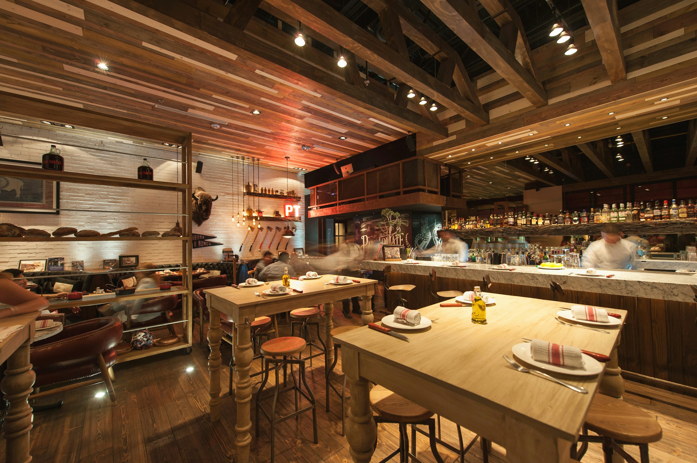 Warm contemporary restaurant dining room set for dinner